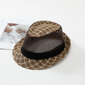 Dettaglio cappello trilby a scacchi in mesh con trama marrone e decoro nastro nero