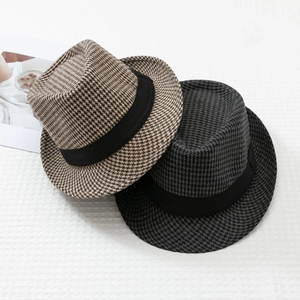 Detail view of classic houndstooth fedora hats with black ribbon bands in two colors