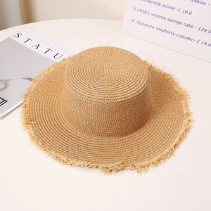 Detailed macro view of woven straw sun hat texture with chic frayed edge and flat top