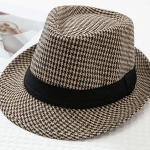 Close-up of houndstooth wool fedora hat with black ribbed ribbon and textured fabric