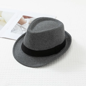 Detail shot of a dark grey fedora hat featuring a premium felt texture and black ribbon