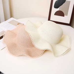 Women's summer sun hats in pink and beige with wavy lace edges for beach vacation