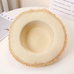 Flat top straw sun hat with frayed tassel edges for beach travel and sun protection
