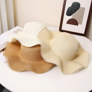 Three wavy edge woven straw hats for women in white, khaki, and caramel beach style