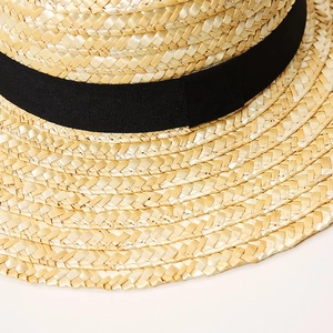 Classic straw sun hat with black ribbon band and wide brim for summer beach vacations