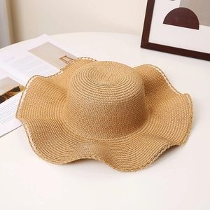Detailed straw sun hat view featuring wavy edges and delicate white lace trim accents