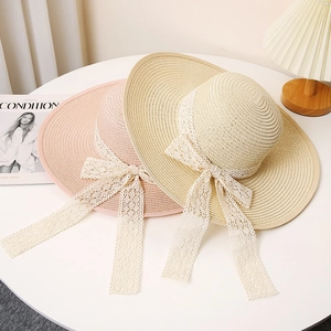 Wide brim straw sun hats with elegant white lace ribbons and bows for summer outdoor wear