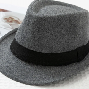 Detailed macro view of dark grey wool felt fedora with black grosgrain ribbon trim