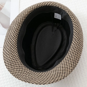 Close-up of houndstooth fedora lining with size 58cm and 80% polyester material label