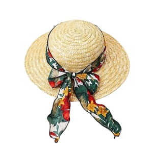 Women straw sun hat with floral ribbon bow and wide brim for summer beach travel