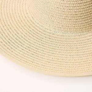Close-up detail of high-density natural straw weave and smooth hem on wide-brim sun hat