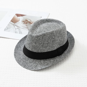 Detailed texture of grey woven jazz fedora hat with a black grosgrain decorative band
