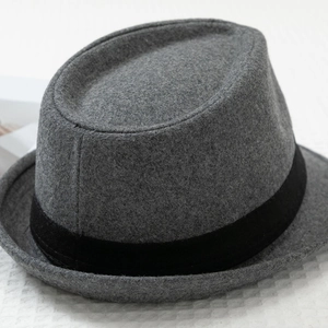 Detail view of medium grey wool felt Fedora hat with black ribbon band on white background
