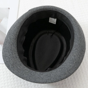 Detail view of dark gray felt fedora hat interior with 58cm size label and black lining