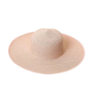 Women's wide-brim straw sun hat in light pink woven fabric for summer beach vacations
