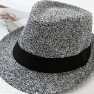Detailed macro view of the grey textured wool blend fabric and black grosgrain ribbon