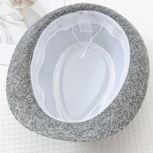 Detail of light grey fedora interior with white mesh lining and adjustable drawstring