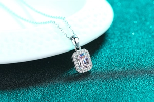 Macro shot of an emerald-cut radiant moissanite pendant on a sterling silver chain