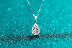Macro shot of S925 sterling silver pear-shaped moissanite pendant with halo setting