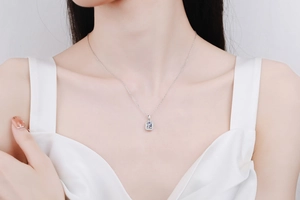 Elegant model wearing an S925 silver necklace featuring a rectangular emerald-cut pendant
