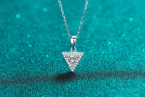 Close-up of sparkling S925 silver necklace with a triangle moissanite pendant