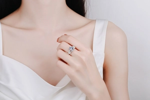 Macro detail of a 3-carat rectangular moissanite ring with a crisscross pavé band