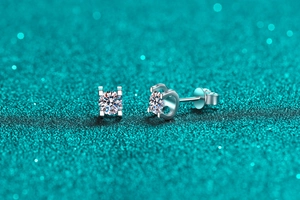 Macro detail of S925 sterling silver stud earrings with 4-prong moissanite setting