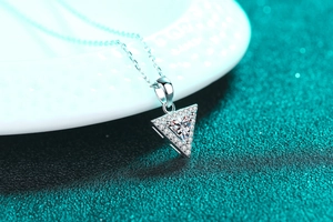 Detailed view of sterling silver necklace with sparkling triangle moissanite pendant