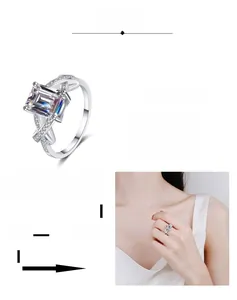Detail of emerald cut moissanite ring with crisscross band and multi-layer plating