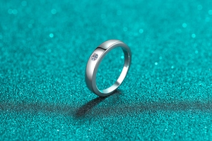 Macro shot of minimalist S925 sterling silver ring with centered moissanite stone