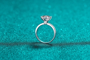 Detailed close-up of a 3-carat moissanite ring with six-prong setting and side accents
