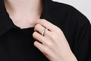 Close-up of minimalist S925 sterling silver ring with inset moissanite stone on hand