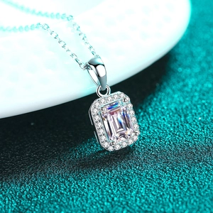 Elegant S925 sterling silver necklace with emerald cut moissanite pendant on green background