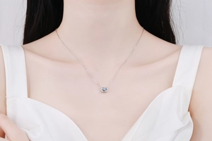 Close-up of minimalist S925 sterling silver necklace with square moissanite on model