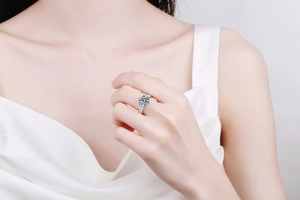 Detailed view of a 3 carat moissanite ring with six-prong setting on a model's hand