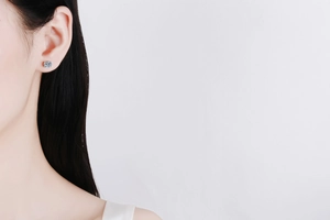 Detail of S925 sterling silver stud earring with brilliant cut moissanite on ear