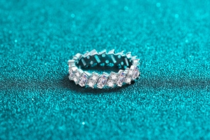 Macro detail of S925 sterling silver eternity band with rectangular and round cut moissanite