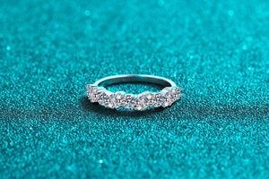Macro detail of S925 silver ring featuring alternating round and baguette moissanite stones