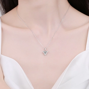 Elegant 925 sterling silver necklace with triangular moissanite pendant on a model