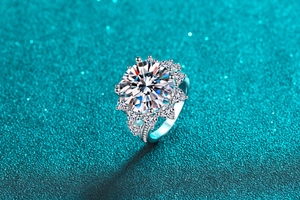Macro shot of 10 carat round brilliant moissanite ring with halo petal design