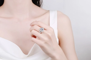 Macro shot of S925 silver ring featuring rectangular radiant cut stone on model hand