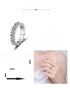 Detail view of eternity band featuring rectangular Moissanite stones and plated silver