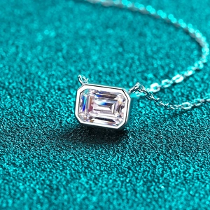Elegant S925 sterling silver necklace featuring emerald cut moissanite on green background