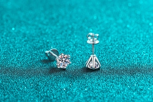 Macro shot of 925 silver six-claw moissanite stud earrings with secure screw backs