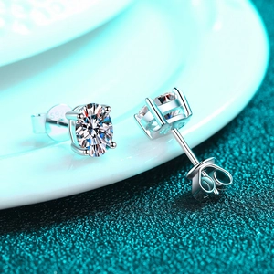 Elegant S925 sterling silver four-prong stud earrings featuring brilliant round moissanite