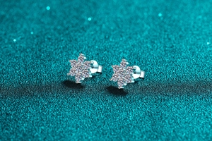 Macro shot of silver sunflower stud earrings with sparkling moissanite cluster details