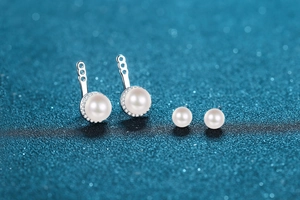 Macro shot of detachable S925 sterling silver earrings with freshwater pearls and moissanite