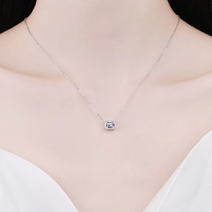 Elegant S925 sterling silver necklace with emerald cut moissanite pendant on a model
