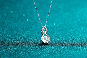 Macro detail of S925 sterling silver infinity pendant necklace with sparkling moissanite