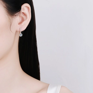 Elegant S925 sterling silver drop earrings with round moissanite on a female model
